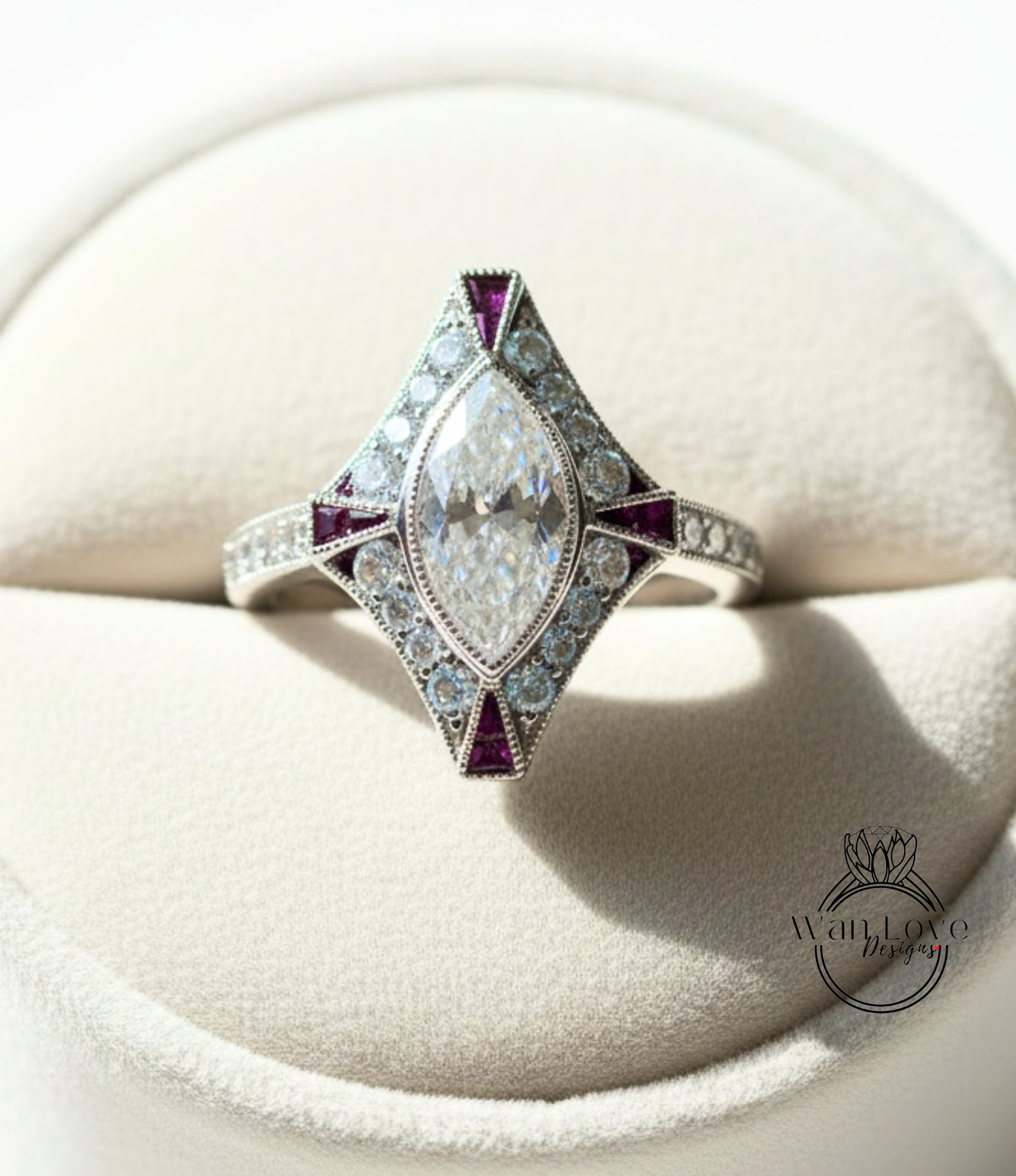 A diamond engagement ring with a large central diamond surrounded by smaller diamonds and colored gemstones, displayed in a white jewelry box.