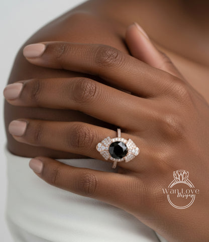A close-up of a person's hand wearing a ring with a large black gemstone, likely a diamond, surrounded by smaller diamonds.