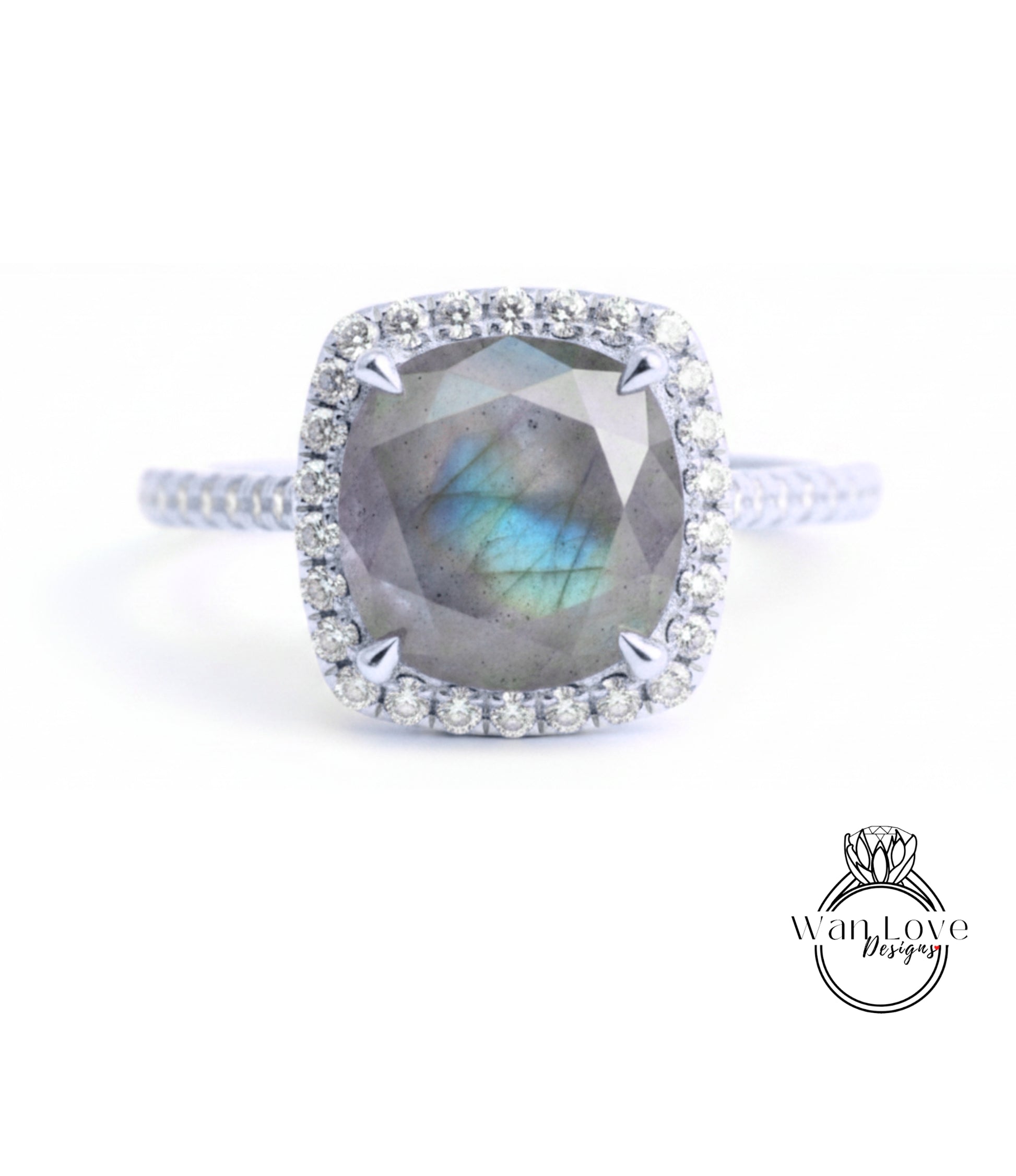 A silver ring with a large, blue-green gemstone at the center, surrounded by a halo of smaller diamonds.