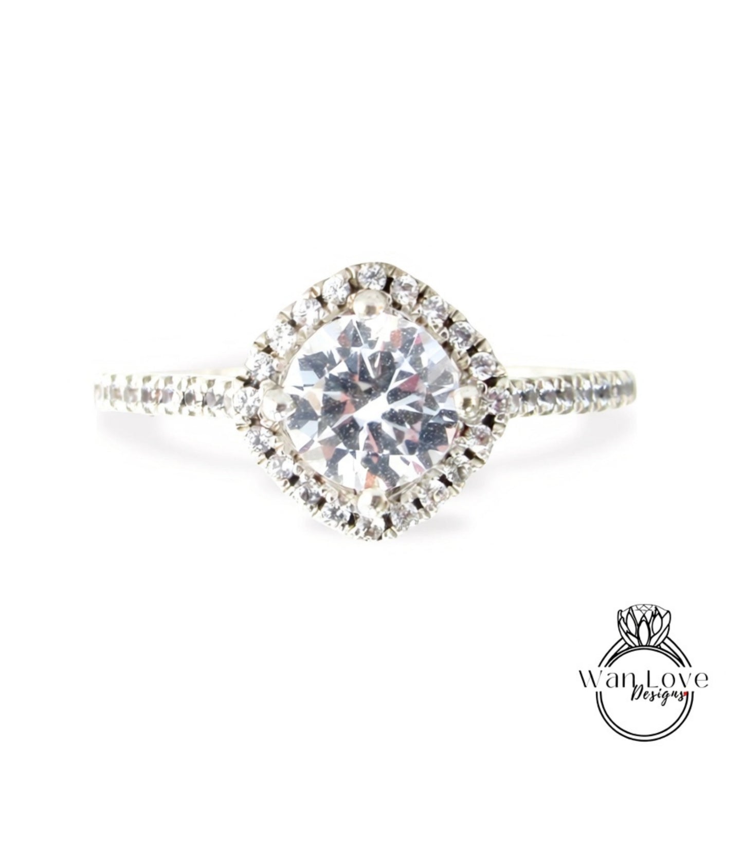 A diamond engagement ring with a large central diamond surrounded by smaller diamonds set in a halo of smaller diamonds.