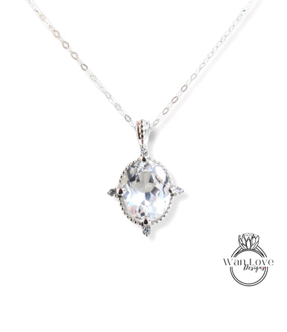 A silver necklace with a large oval-shaped gemstone pendant.