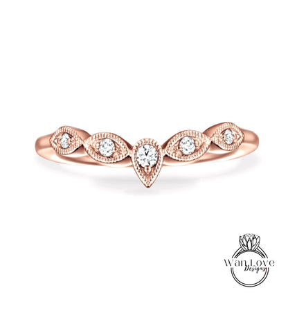 A rose gold ring with a central diamond and smaller diamonds arranged in a decorative pattern around the band.