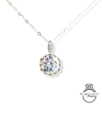 A necklace with a large, clear gemstone pendant, possibly a diamond, hanging from a chain.