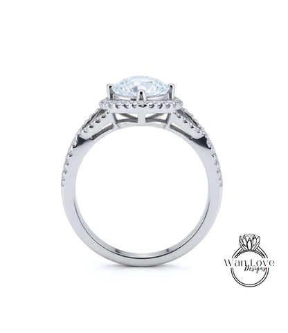 A silver engagement ring with a large central diamond surrounded by smaller diamonds on either side.