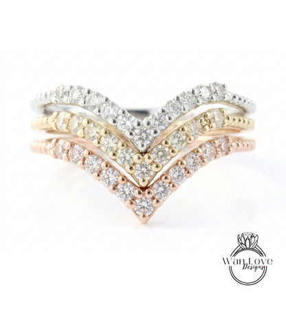 A ring with a diamond-encrusted band featuring three distinct diamond-encrusted tiers, with the middle tier being the largest and the bottom tier being the smallest.