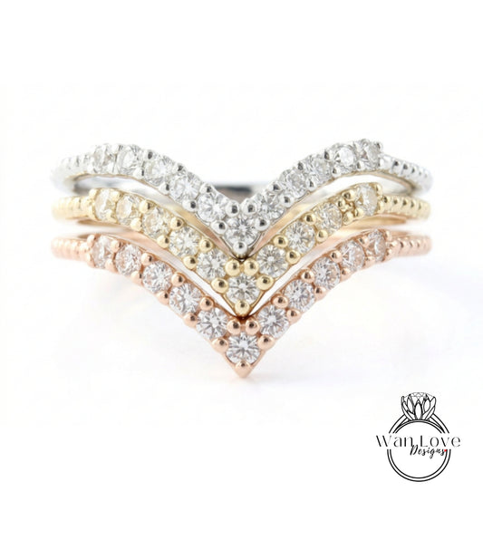 A ring with a diamond-encrusted band featuring three distinct diamond-encrusted tiers, with the middle tier being the largest and the bottom tier being the smallest.