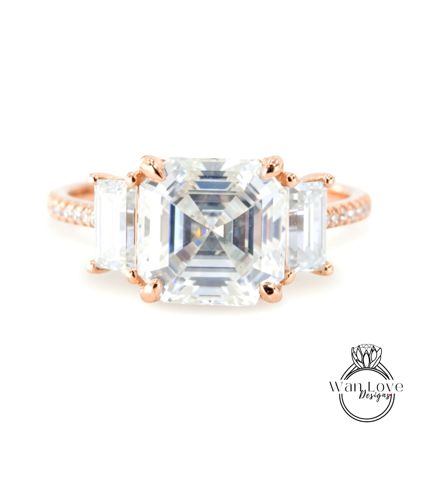 A large, clear gemstone ring with three smaller diamonds set in the center.