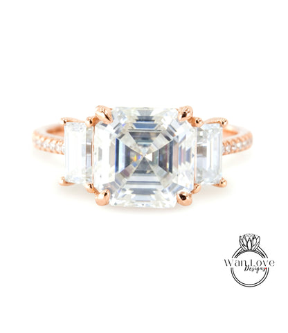 A large, clear gemstone ring with three smaller diamonds set in the center.