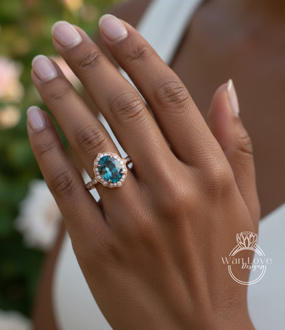 A close-up of a person's hand wearing a gold ring with a blue gemstone, likely an oval-shaped blue gemstone.
