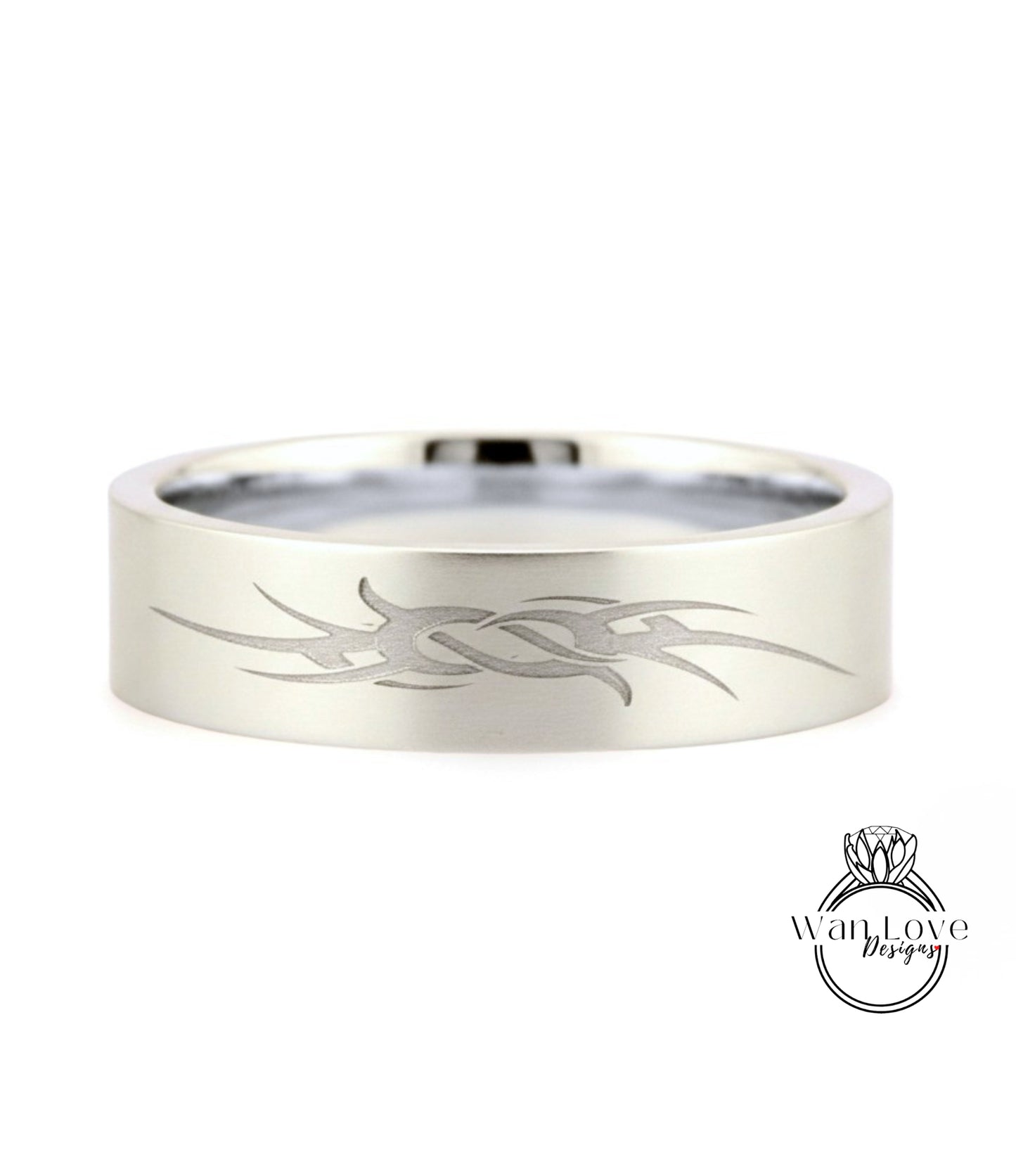 A silver-colored ring with a unique engraved design on its surface.