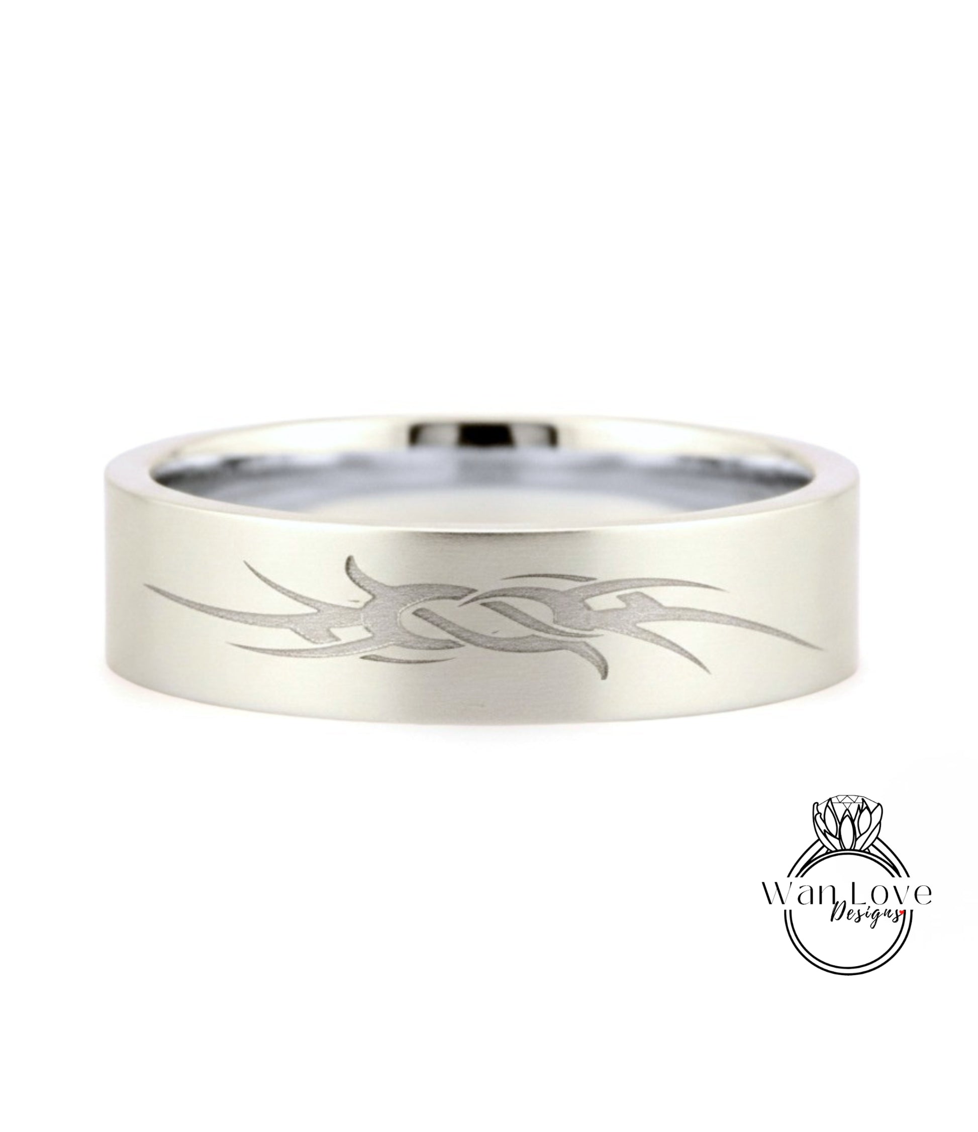 A silver-colored ring with a unique engraved design on its surface.
