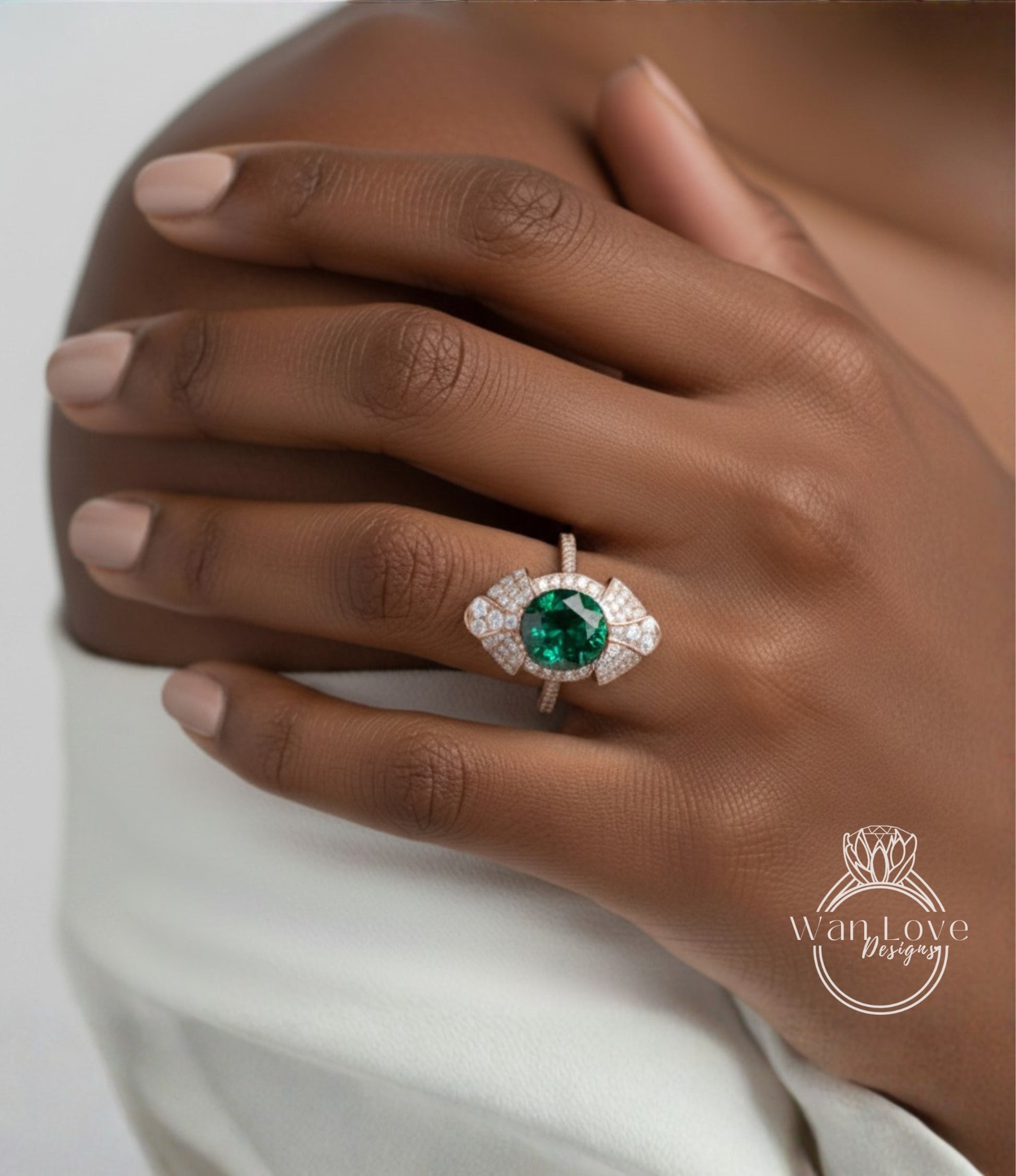 A close-up of a person's hand wearing a large, ornate ring with a large green gemstone.