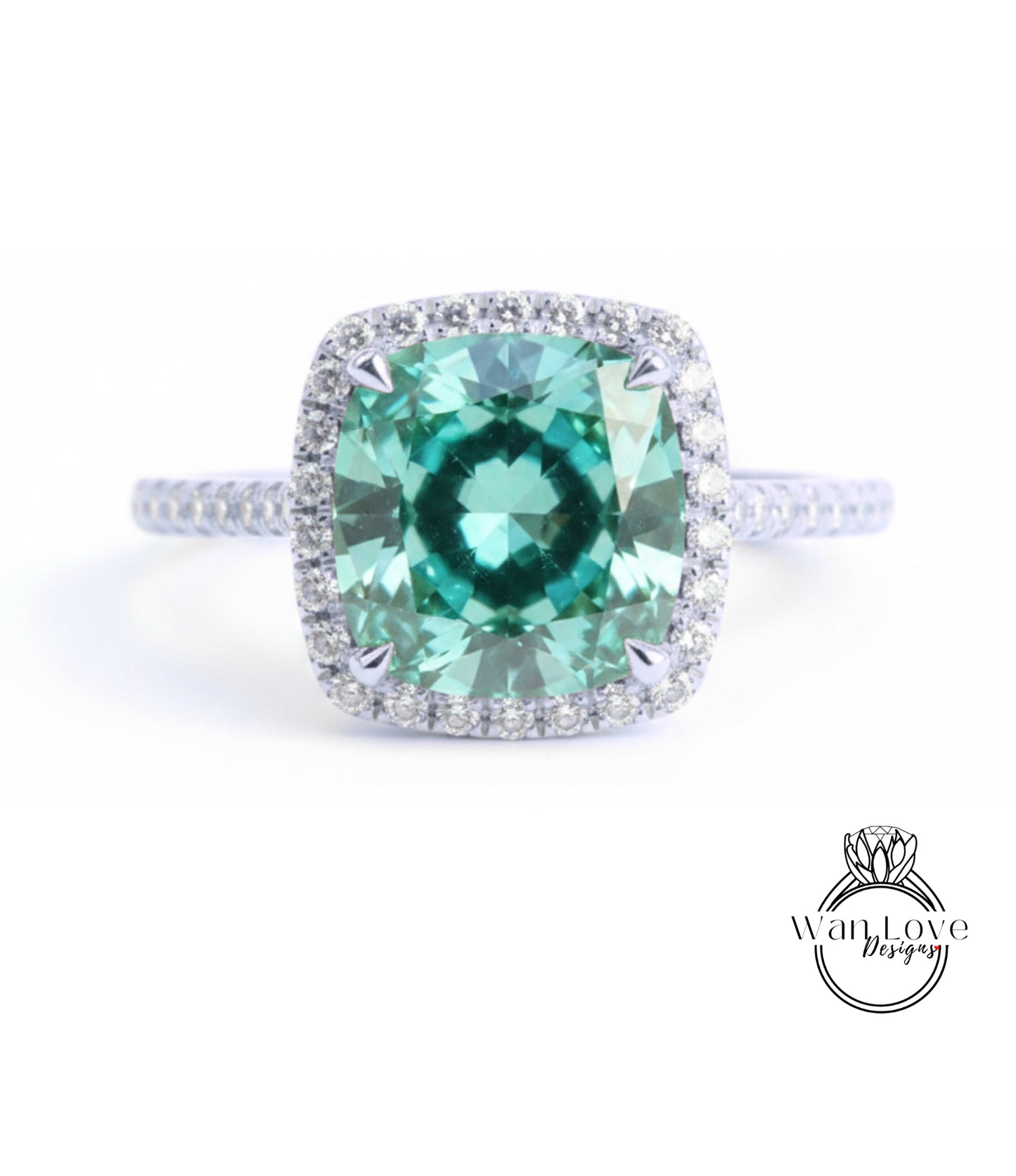 A stunning ring featuring a large, vibrant green gemstone set in a halo of smaller diamonds, with a silver band around the base.
