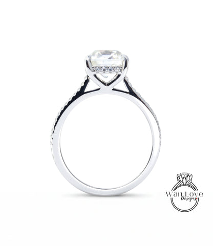 A silver engagement ring with a large diamond set in the center, surrounded by smaller diamonds.