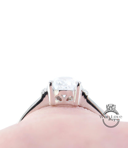 A close-up view of a diamond engagement ring on a person's finger, showcasing the intricate details and sparkle of the diamond.