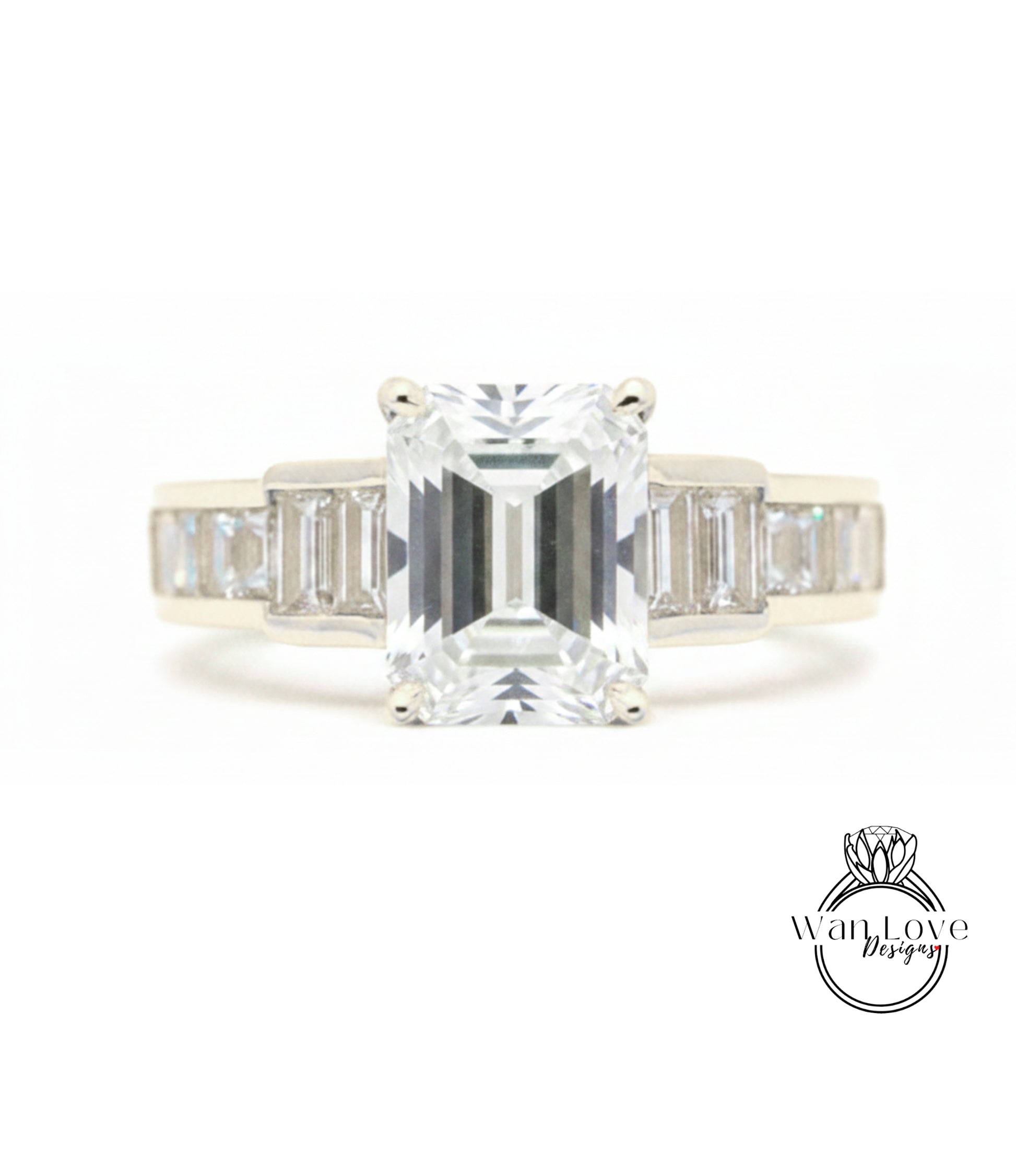A diamond engagement ring with a large central diamond surrounded by smaller diamonds on either side.