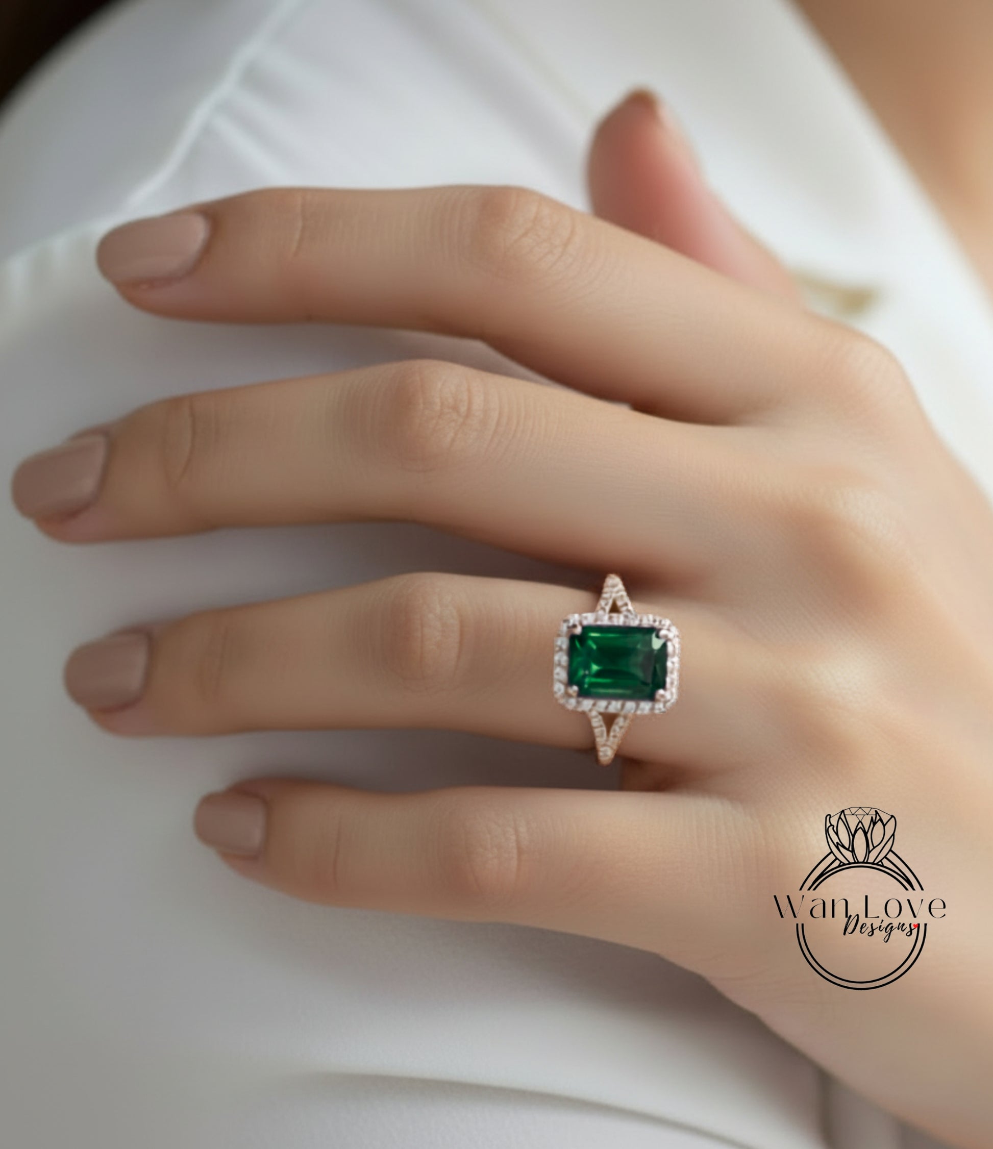 A close-up of a person's hand wearing a ring with a large, green gemstone.