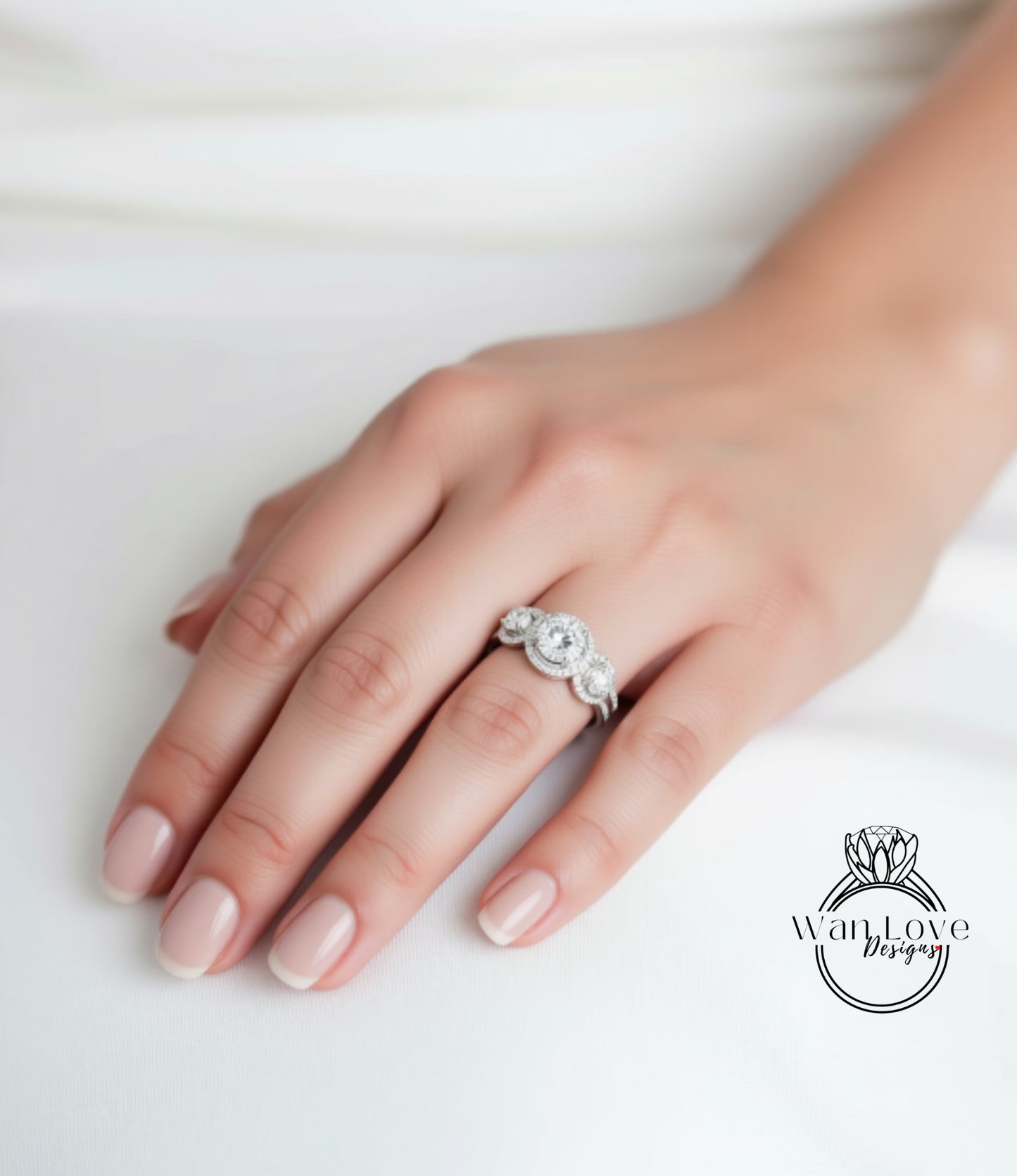 A close-up of a hand wearing a diamond ring on the ring finger.