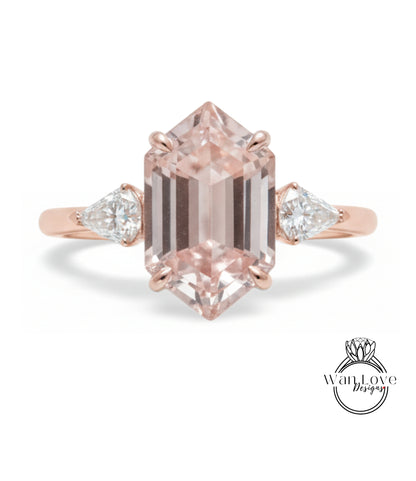 a beautiful engagement ring with a large, irregularly shaped pink gemstone set in a rose gold band.