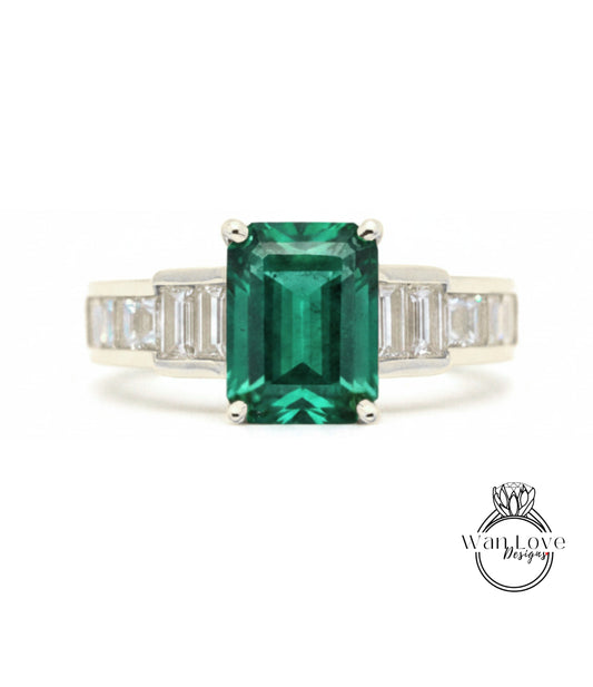 A ring featuring a large, vibrant green gemstone surrounded by smaller diamonds set in a silver band.