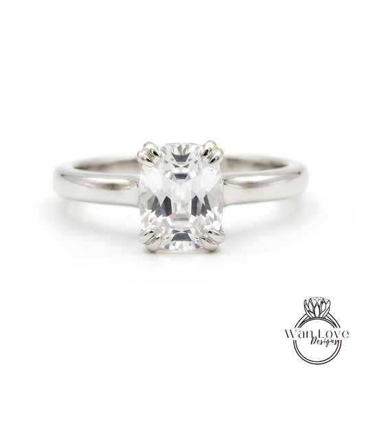 A close-up view of a diamond engagement ring with a large, clear gemstone set in a silver band.