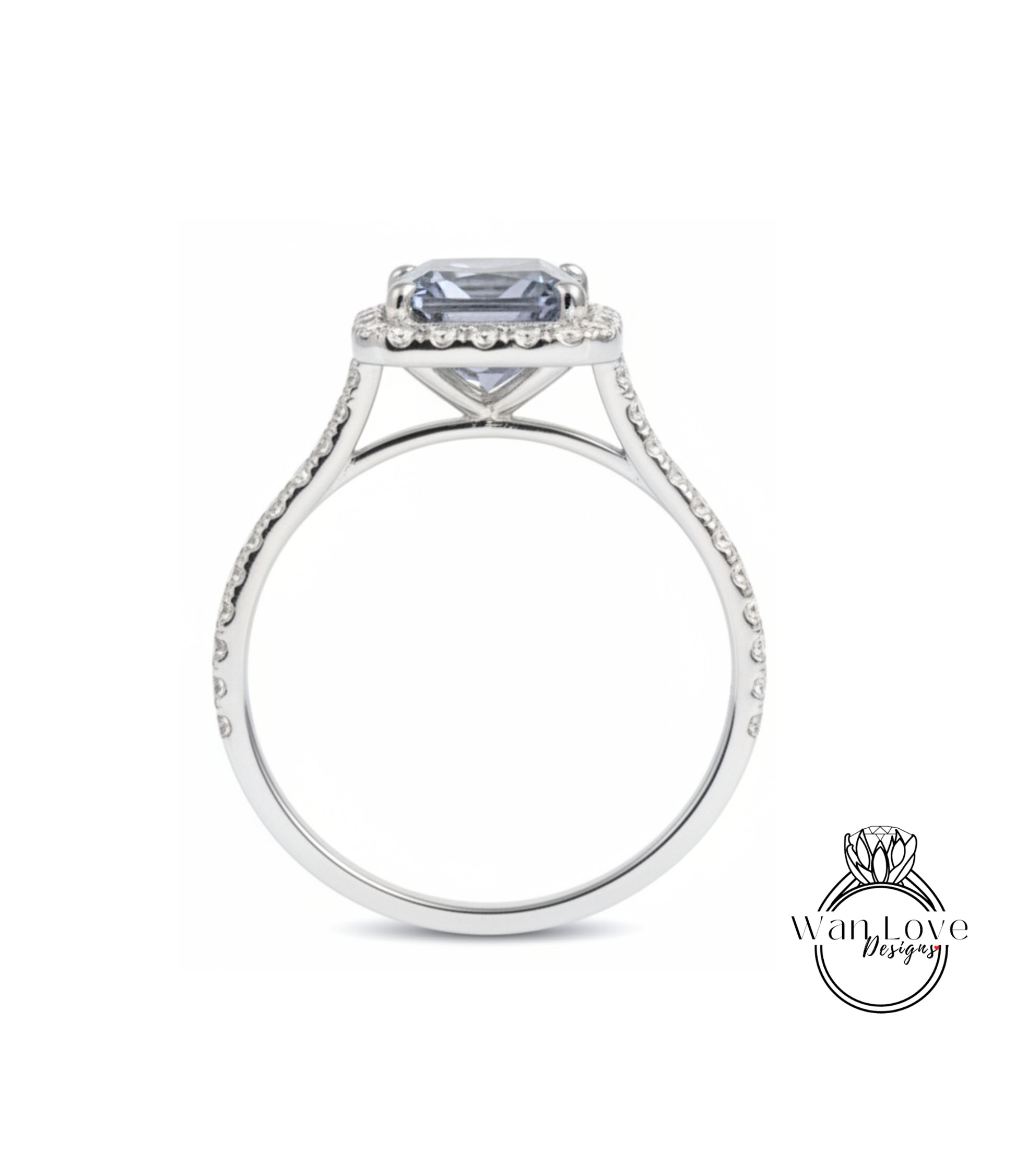 A silver engagement ring with a large blue gemstone set in the center, surrounded by smaller diamonds.