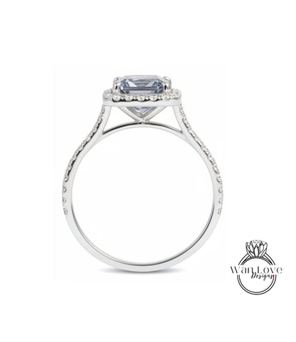 A silver engagement ring with a large blue gemstone set in the center, surrounded by smaller diamonds.