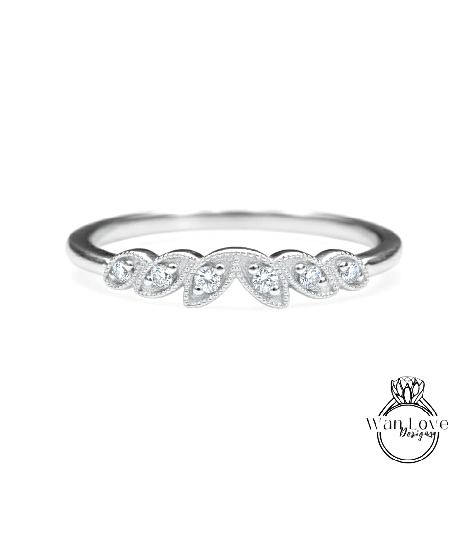 A silver ring with a row of small diamonds set in the center.