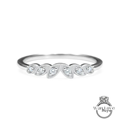 A silver ring with a row of small diamonds set in the center.
