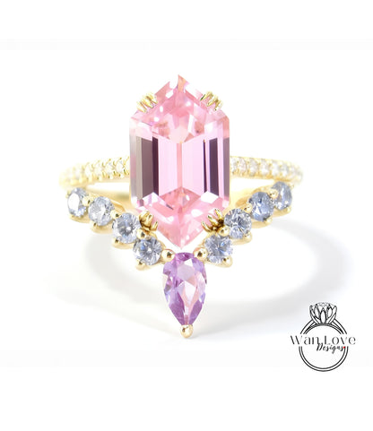 A pink gemstone ring with a gold band and a row of smaller diamonds on either side.
