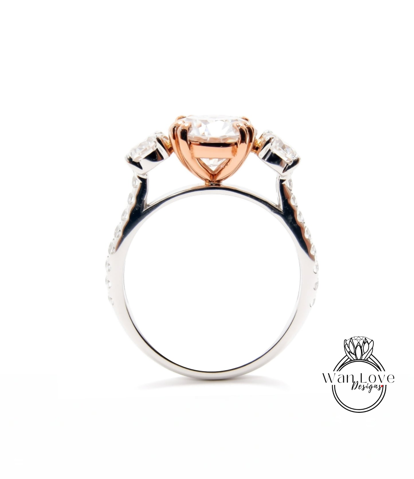 A close-up view of a silver ring with a large central diamond surrounded by smaller diamonds on either side.