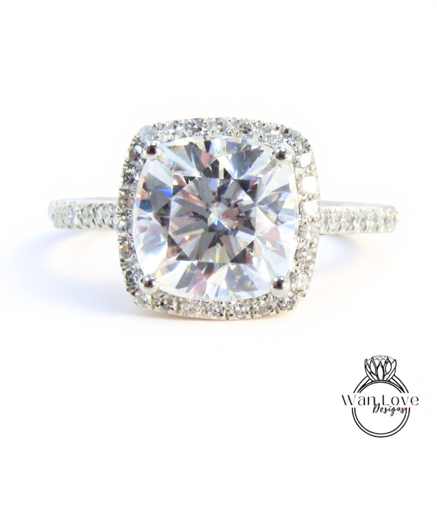 A large, clear diamond engagement ring with a halo of smaller diamonds around the center stone.