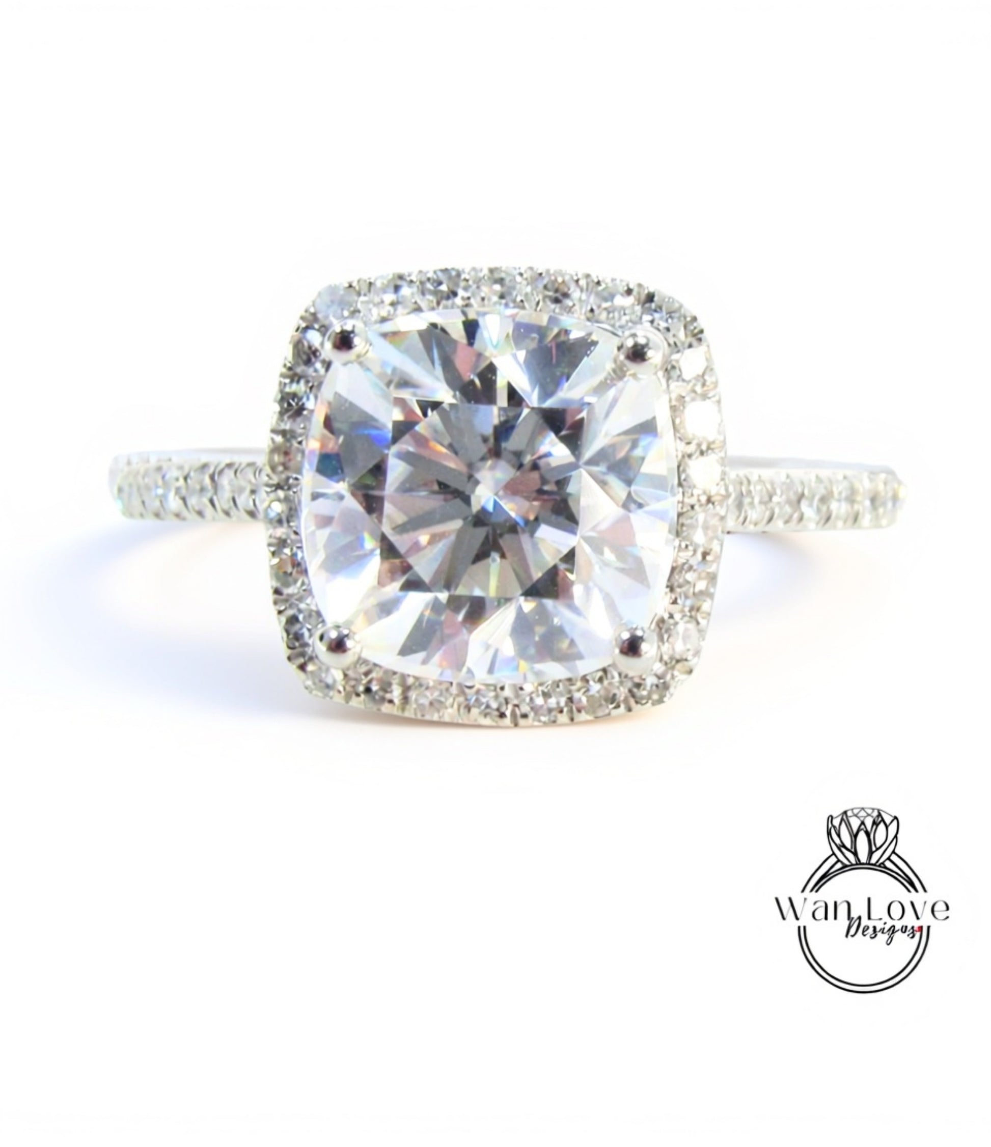 A large, clear diamond engagement ring with a halo of smaller diamonds around the center stone.