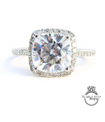 A large, clear diamond engagement ring with a halo of smaller diamonds around the center stone.