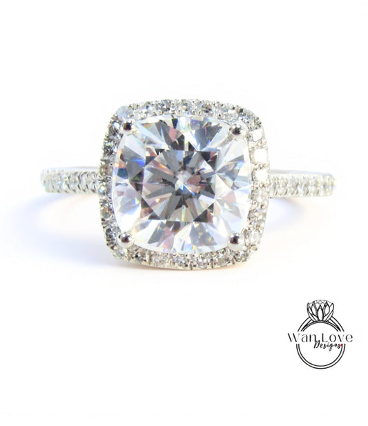 A large, clear diamond engagement ring with a halo of smaller diamonds around the center stone.