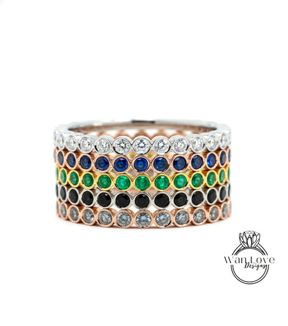 A ring with a row of colorful gemstones, including diamonds and various colored stones, set in a silver band.