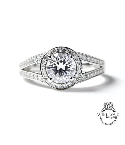A close-up view of a diamond engagement ring with a large central diamond surrounded by smaller diamonds set in a halo.