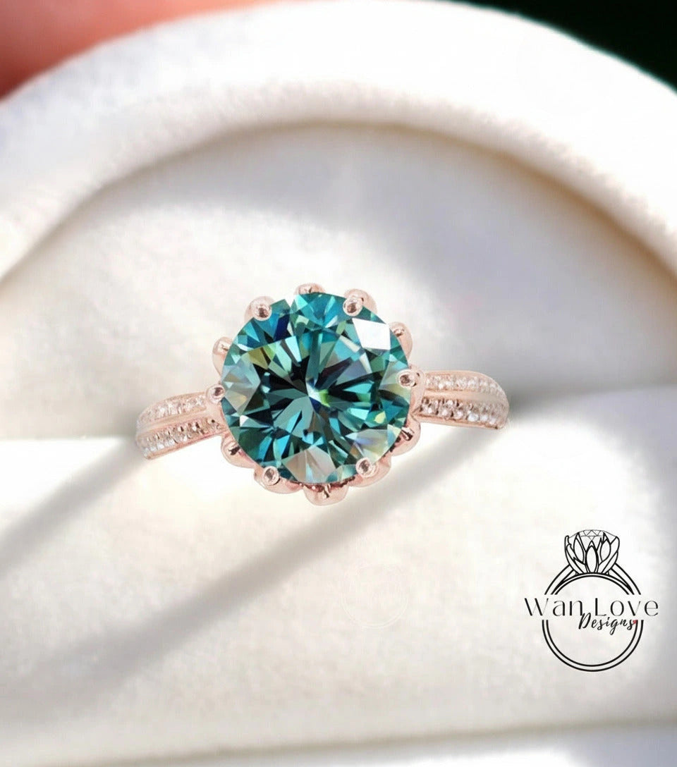 A close-up of a beautiful blue diamond ring with a large central gemstone surrounded by smaller diamonds on the band.