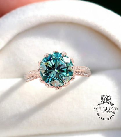 A close-up of a beautiful blue diamond ring with a large central gemstone surrounded by smaller diamonds on the band.