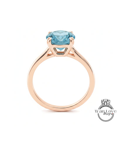 A gold ring with a large blue gemstone set in the center.