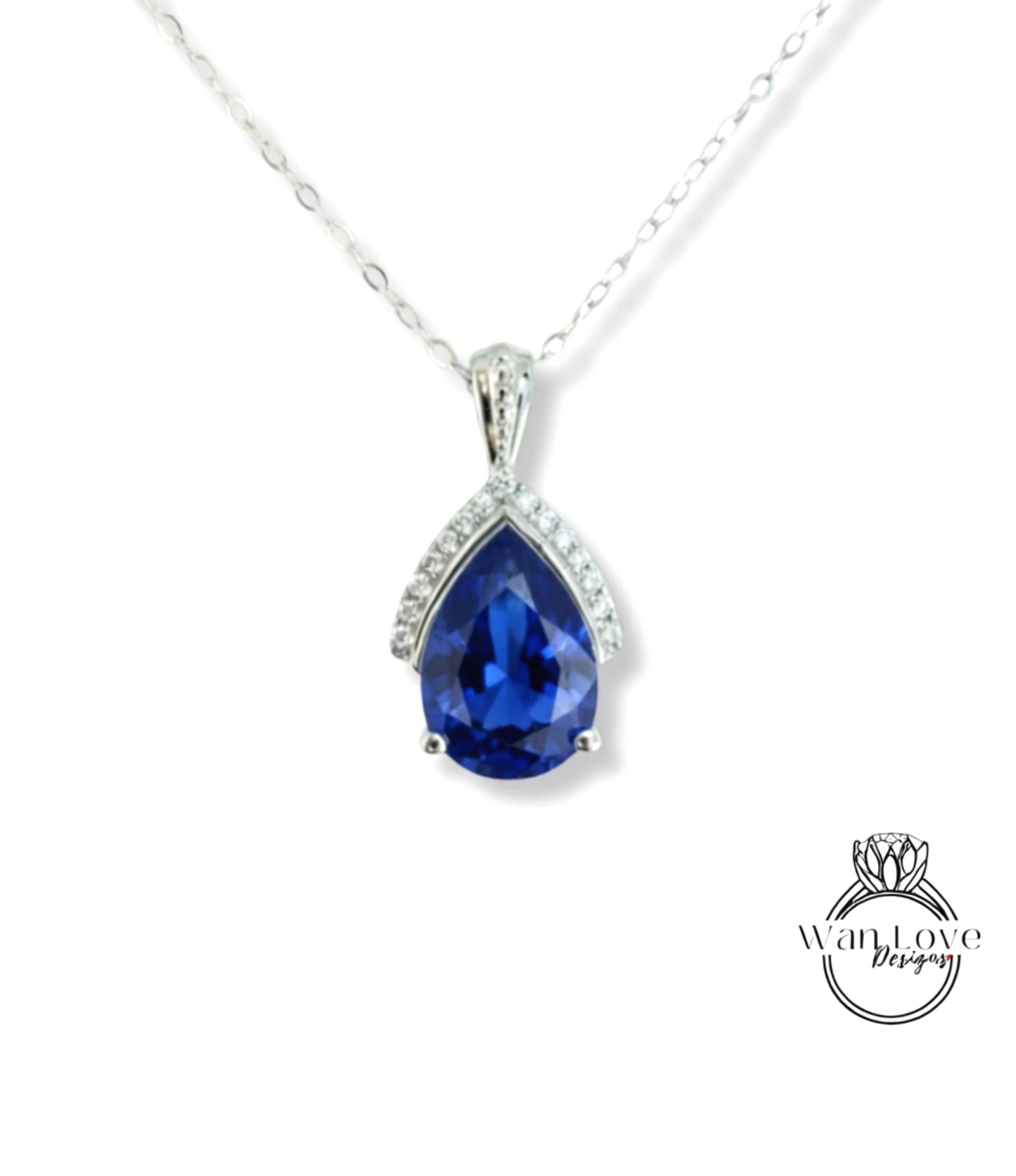 A silver necklace with a large blue gemstone pendant.