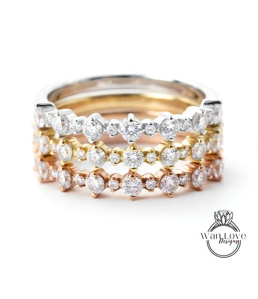 A close-up image of a ring with multiple layers of diamond-encrusted bands, showcasing the intricate design and craftsmanship of the jewelry piece.