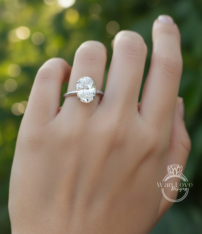 A close-up of a person's hand wearing a diamond engagement ring.