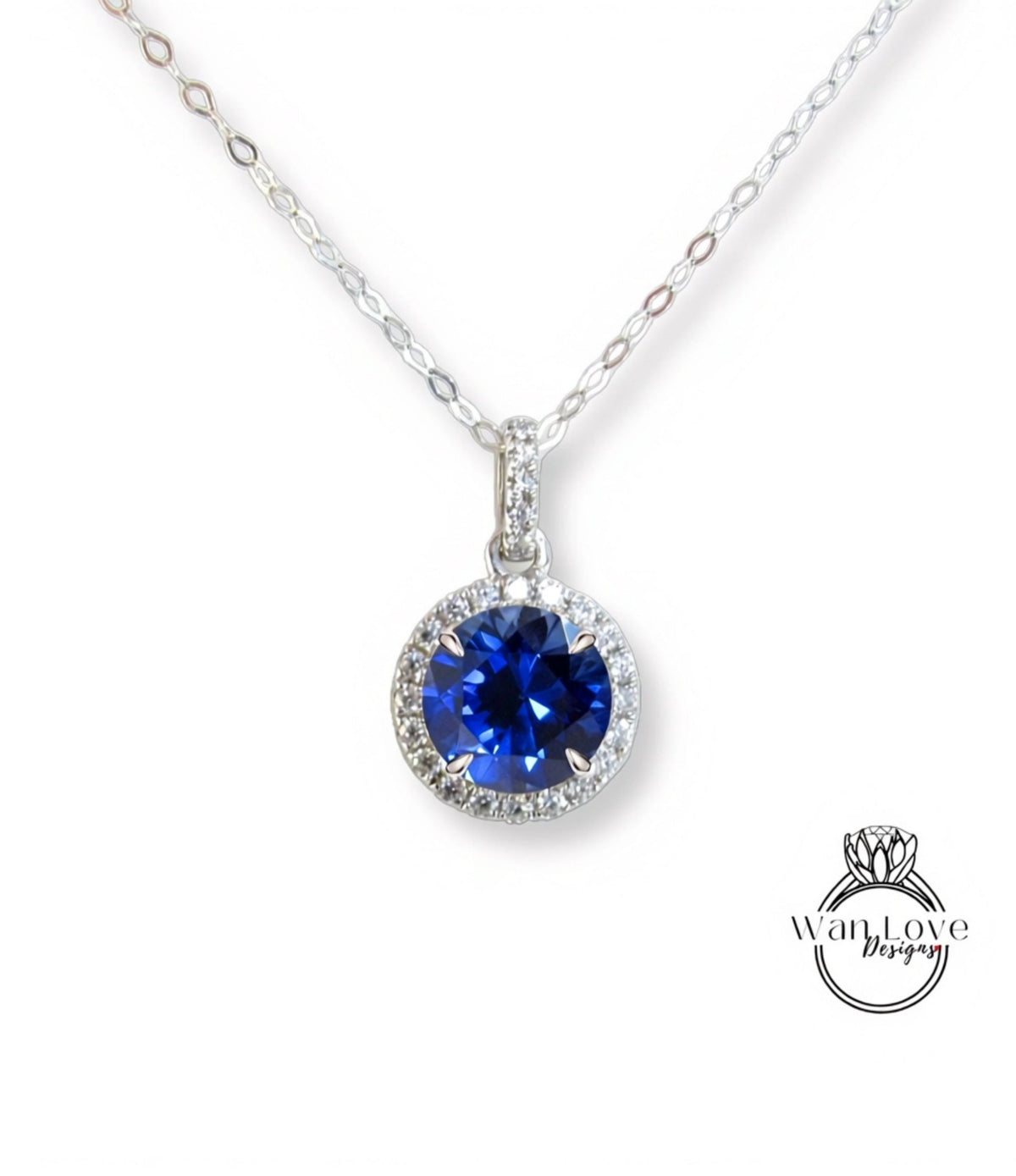 A necklace with a large blue gemstone pendant, surrounded by a halo of smaller diamonds.
