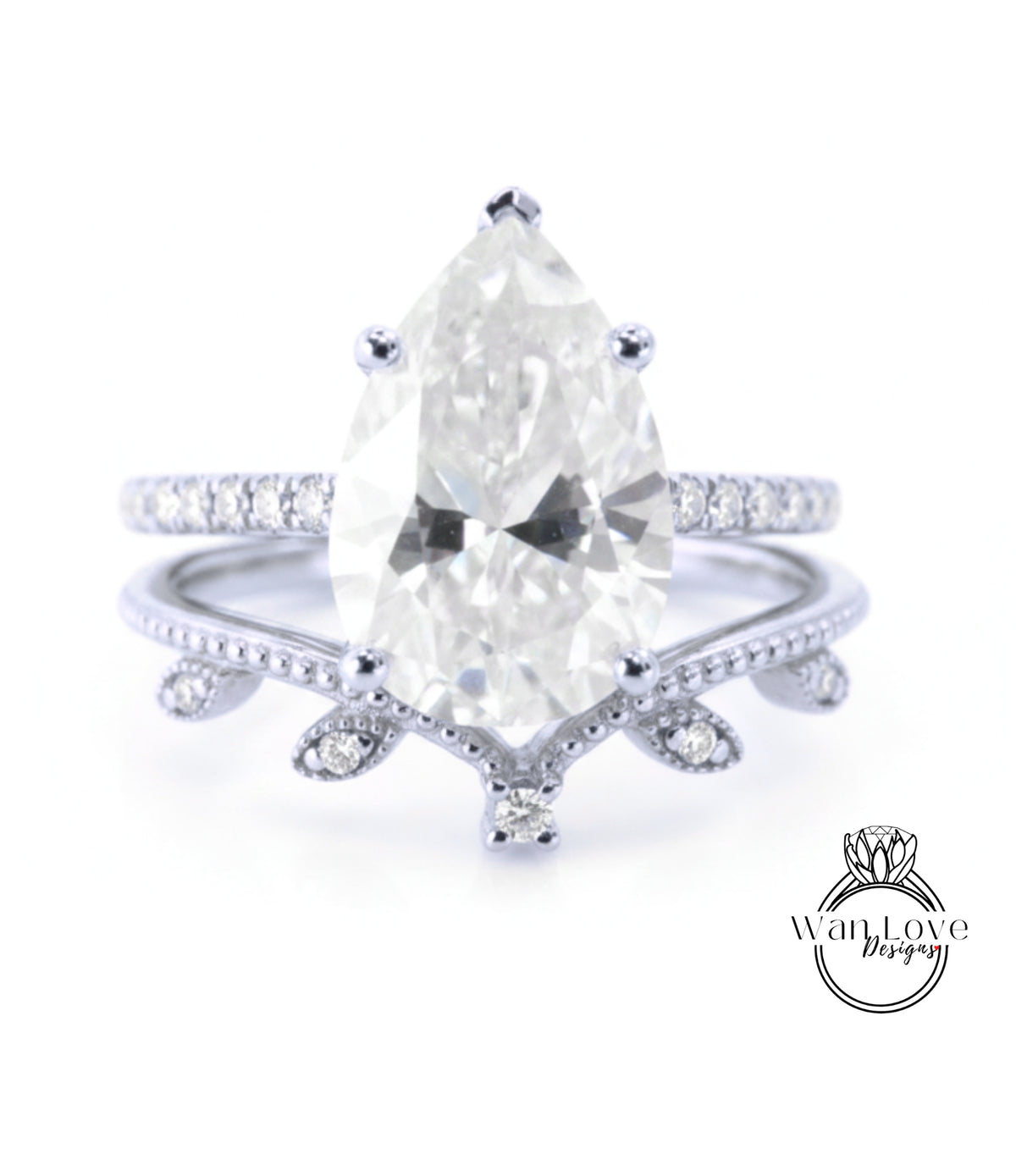 A close-up image of a diamond engagement ring with a large pear-shaped diamond set in a band with smaller diamonds.