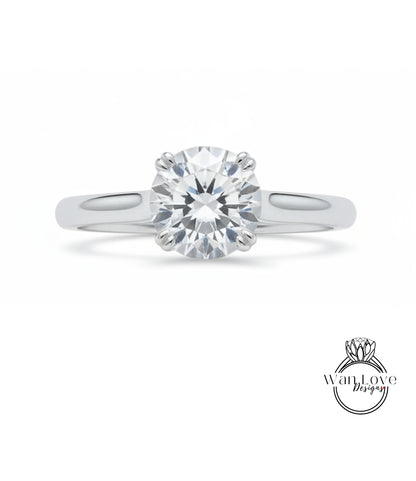 A close-up view of a diamond engagement ring with a large, brilliant-cut diamond set in a silver band.