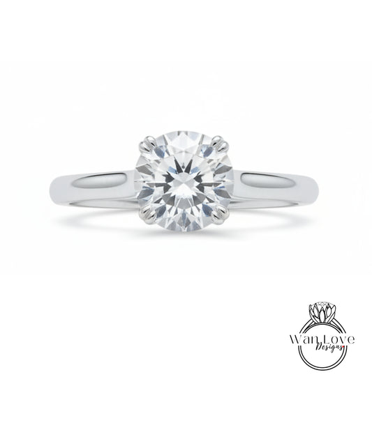 A close-up view of a diamond engagement ring with a large, brilliant-cut diamond set in a silver band.