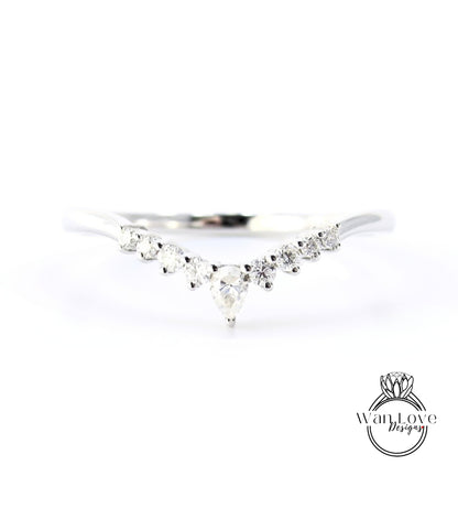 A silver ring with a large central diamond surrounded by smaller diamonds arranged in a v-shape.