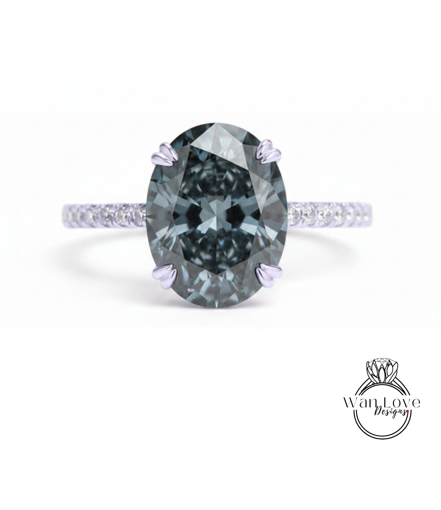 A close-up of a large, dark blue diamond ring with a smaller diamond set in the band.