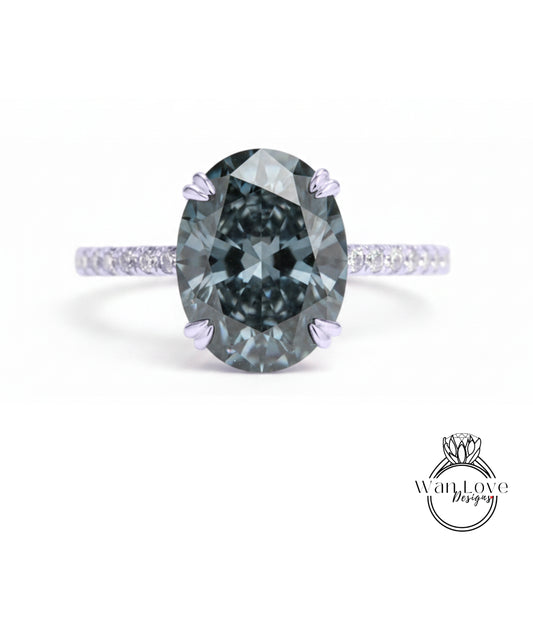 A close-up of a large, dark blue diamond ring with a smaller diamond set in the band.